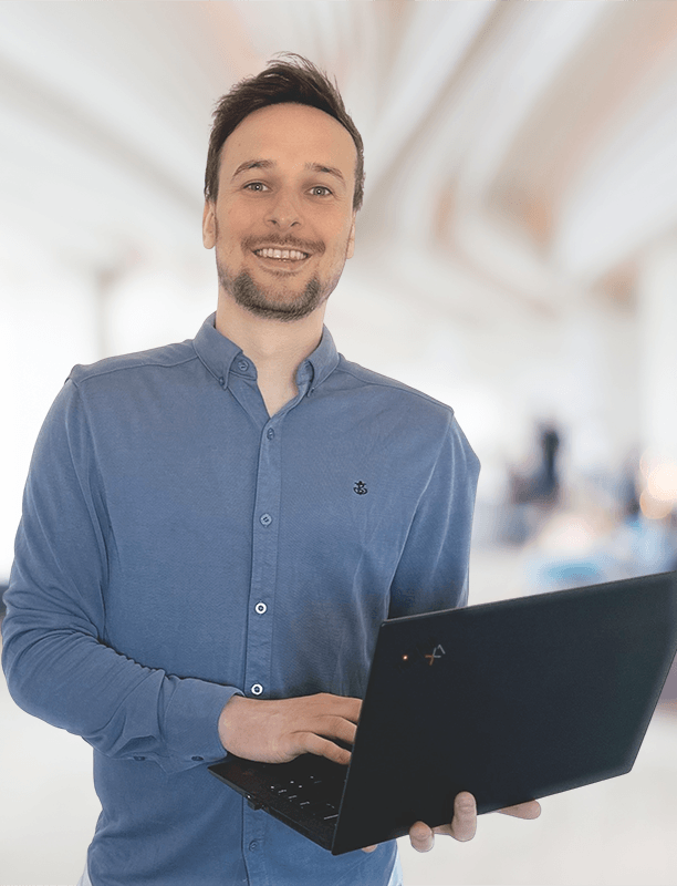 Ross from Sort My PC holding a laptop